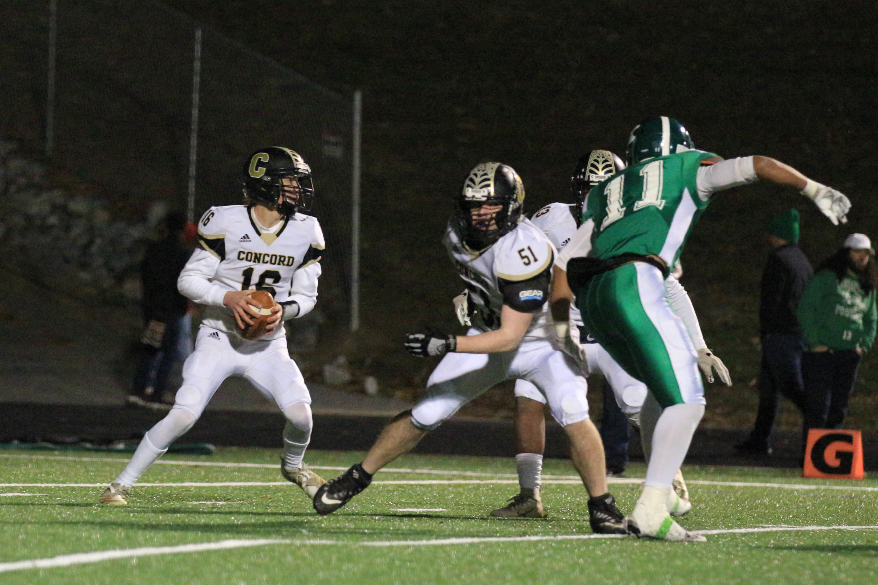 ALBrown vs Concord. Zach Jenkins (16) looks down field while Peter Petroff (51) tries to give him some time Joan Moore/Sprcial to The Independent Tribune